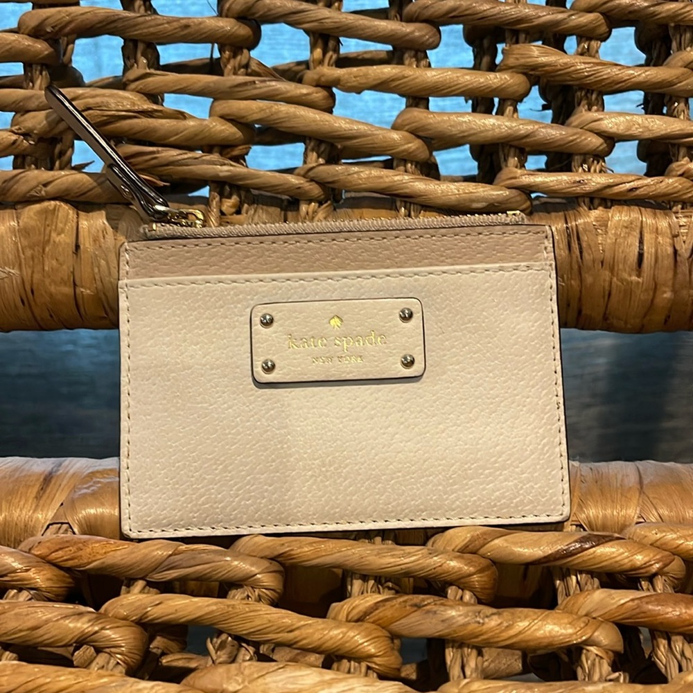 Kate Spade cream card holder with zipper pocket.